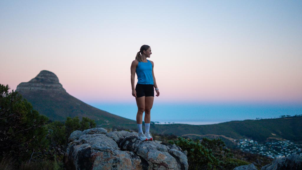 Runner on a summit boulder at dusk, Lion’s Head behind