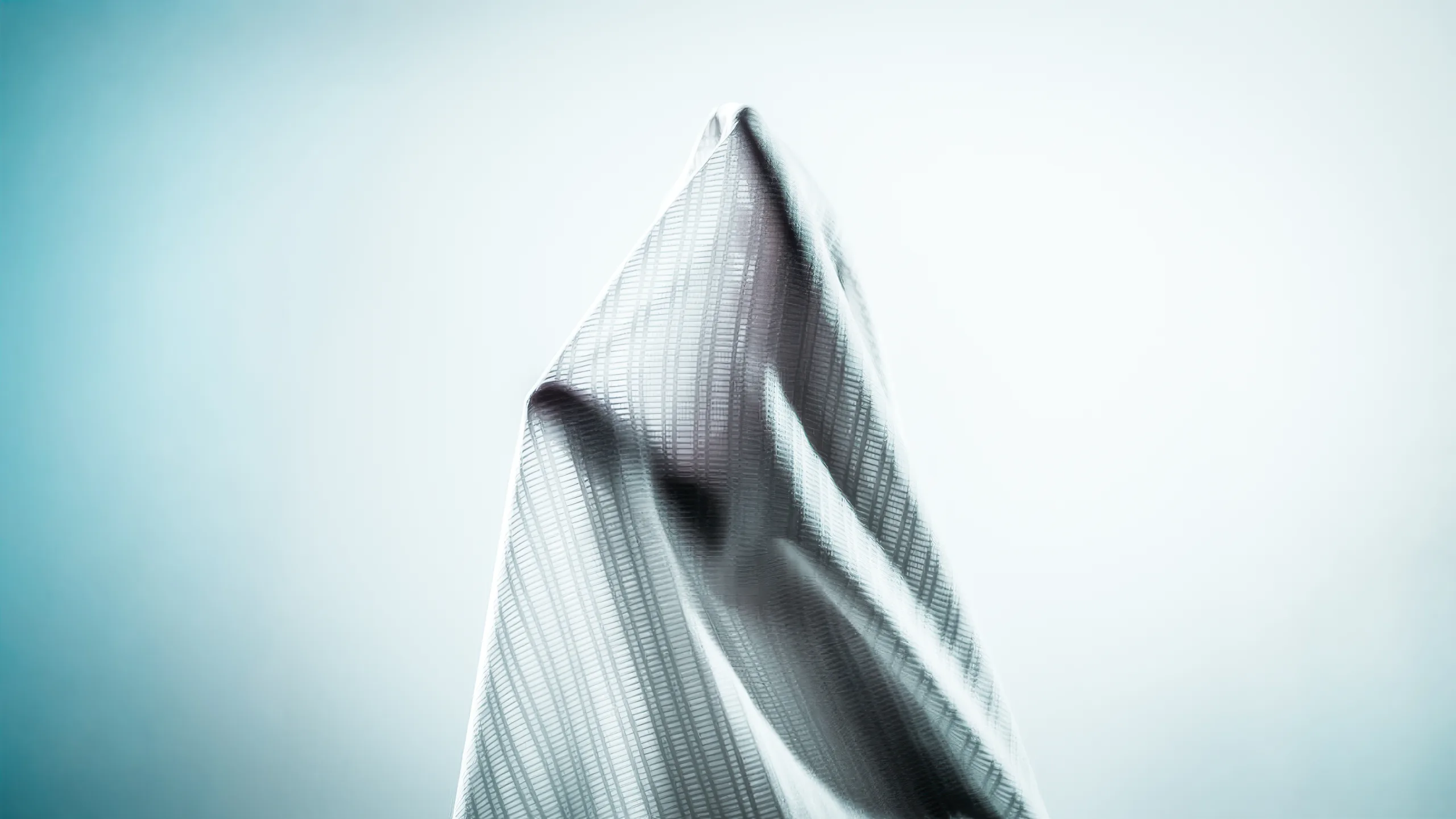Aerias G177 jacquard mesh suspended mid-air, backlit to show the woven airflow channels